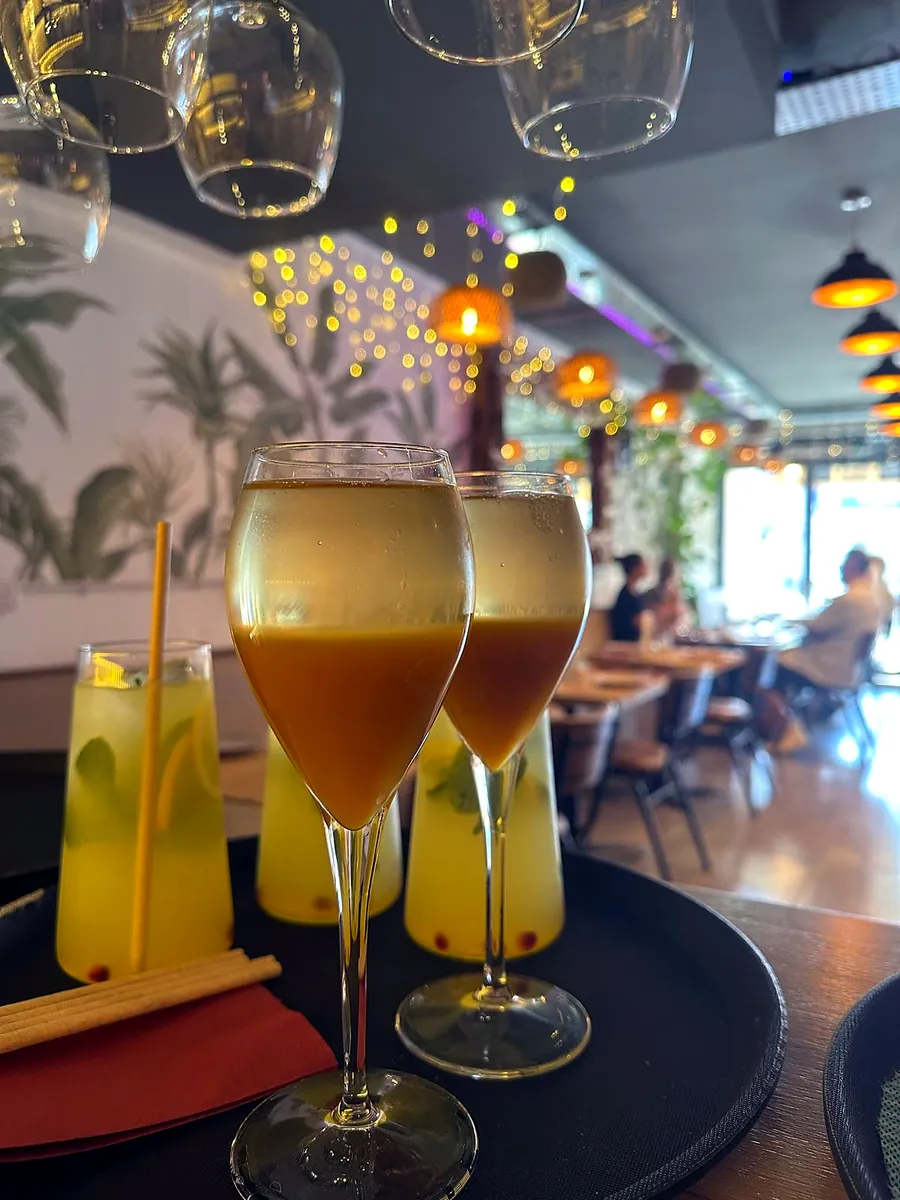 Prosecco flutes and fruit drinks in the dining room under the pendant lights