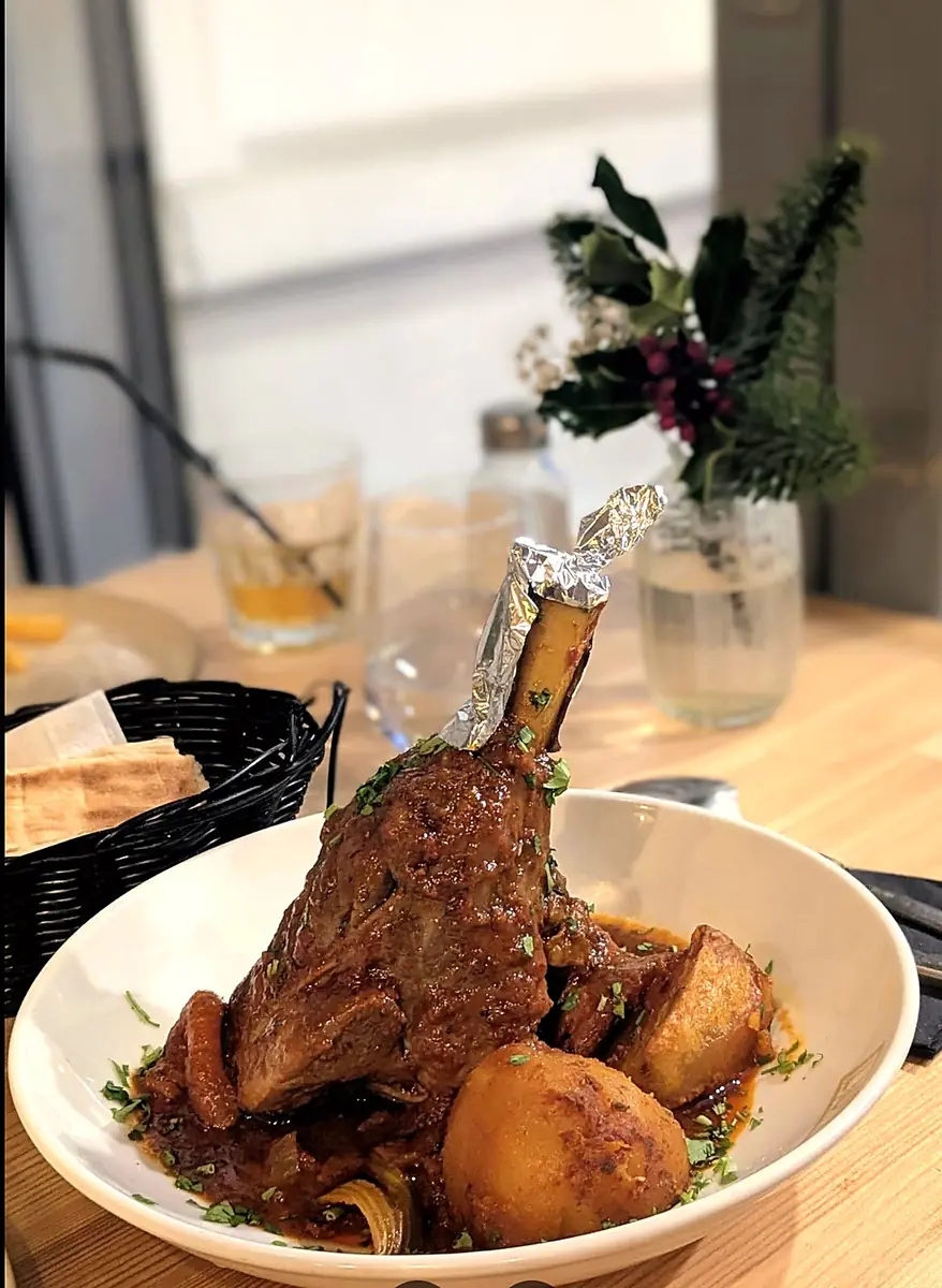Slow-cooked lamb shank with potatoes in a rich sauce